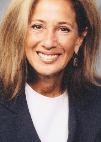 Blond woman with white shirt and black jacket