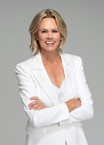 Woman with blond hair in white suit