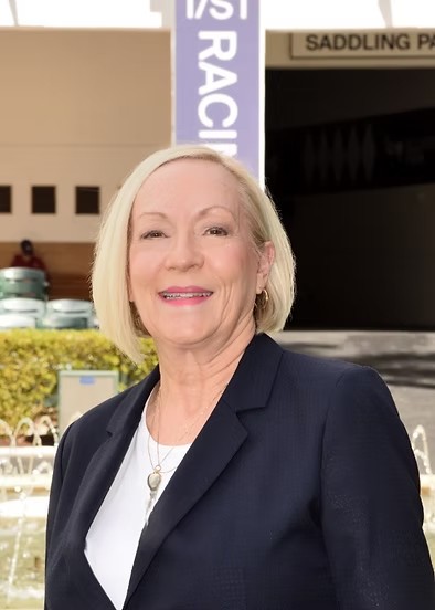 Blond woman in black suit jacket